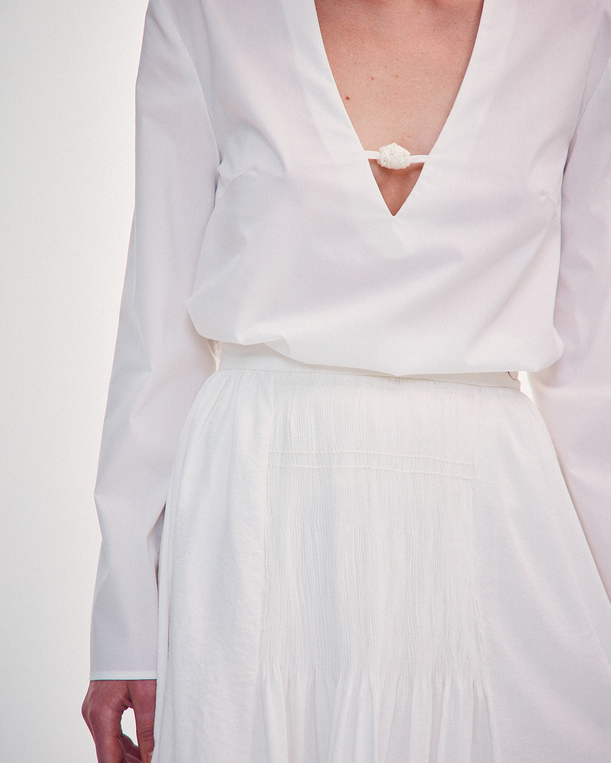 Shirt with a knitted button