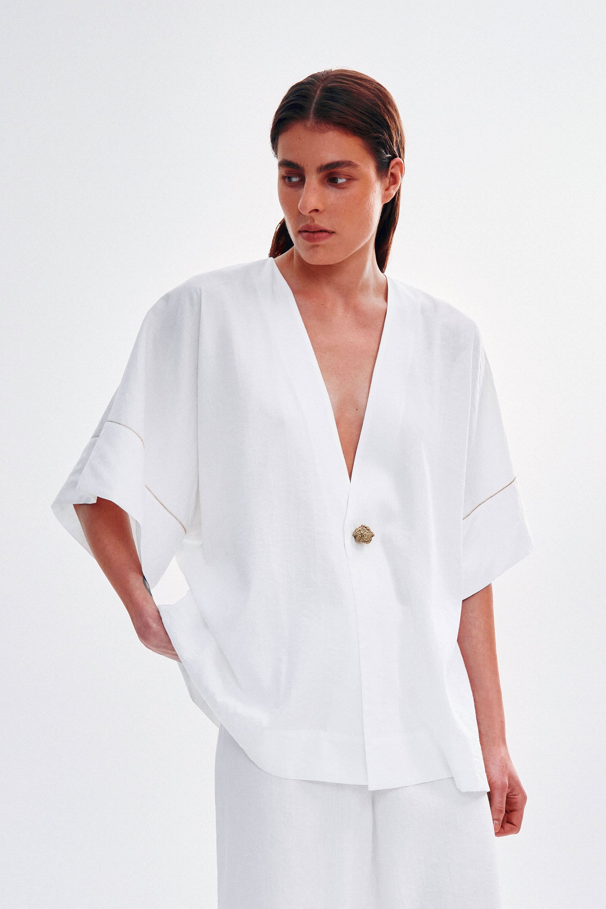 Shirt with a knitted gold button